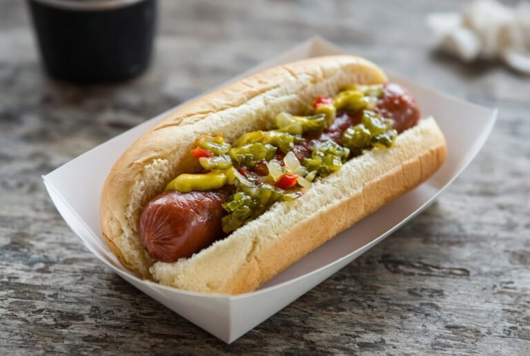 Hot dog in a bun with mustard and relish